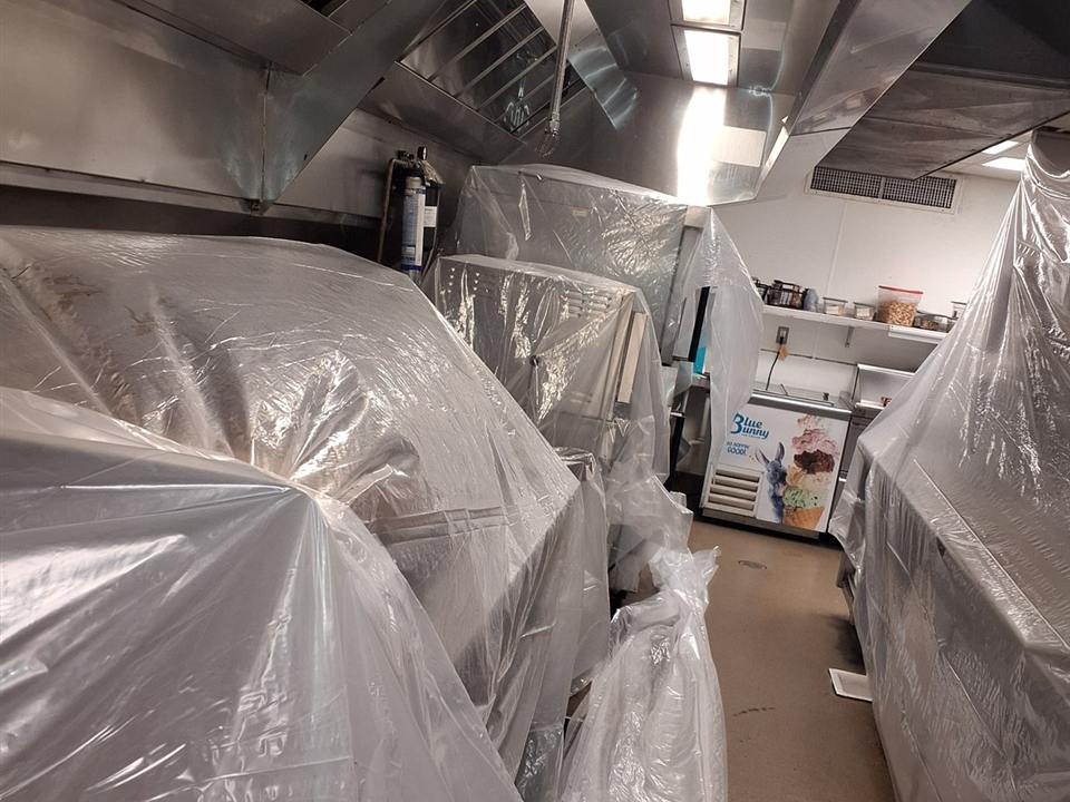 Commercial kitchen protected and prepared for professional hood cleaning service
