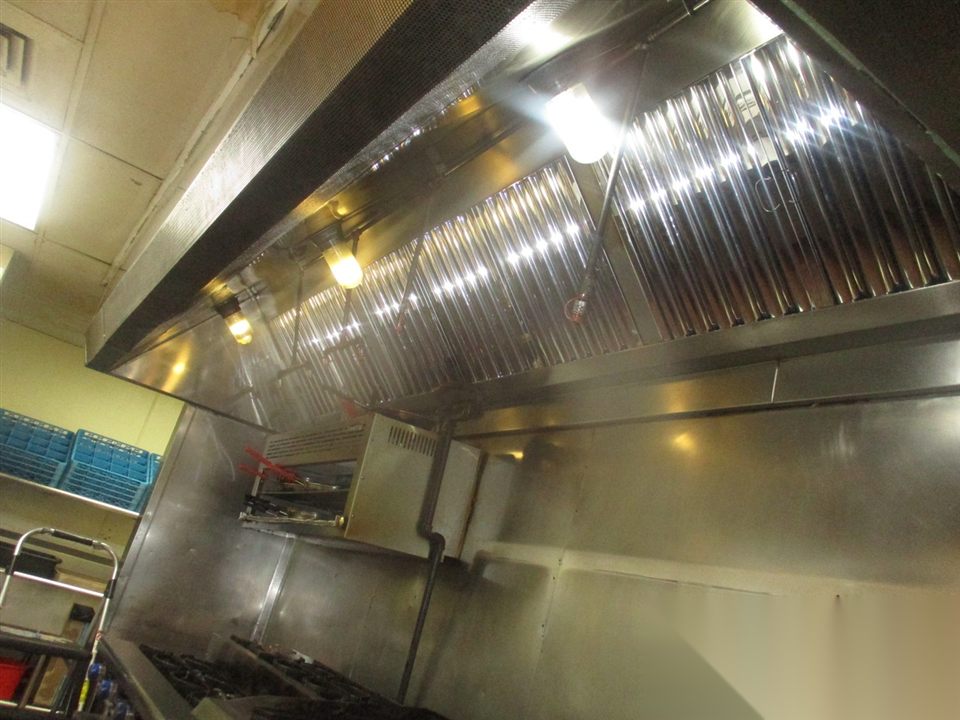 Commercial kitchen hood filter system cleaned and maintained for Fire Code compliance