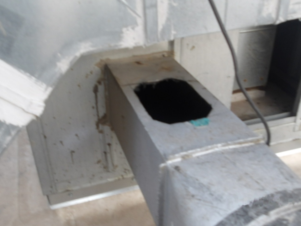 Commercial kitchen exhaust duct access opening prepared for duct cleaning service